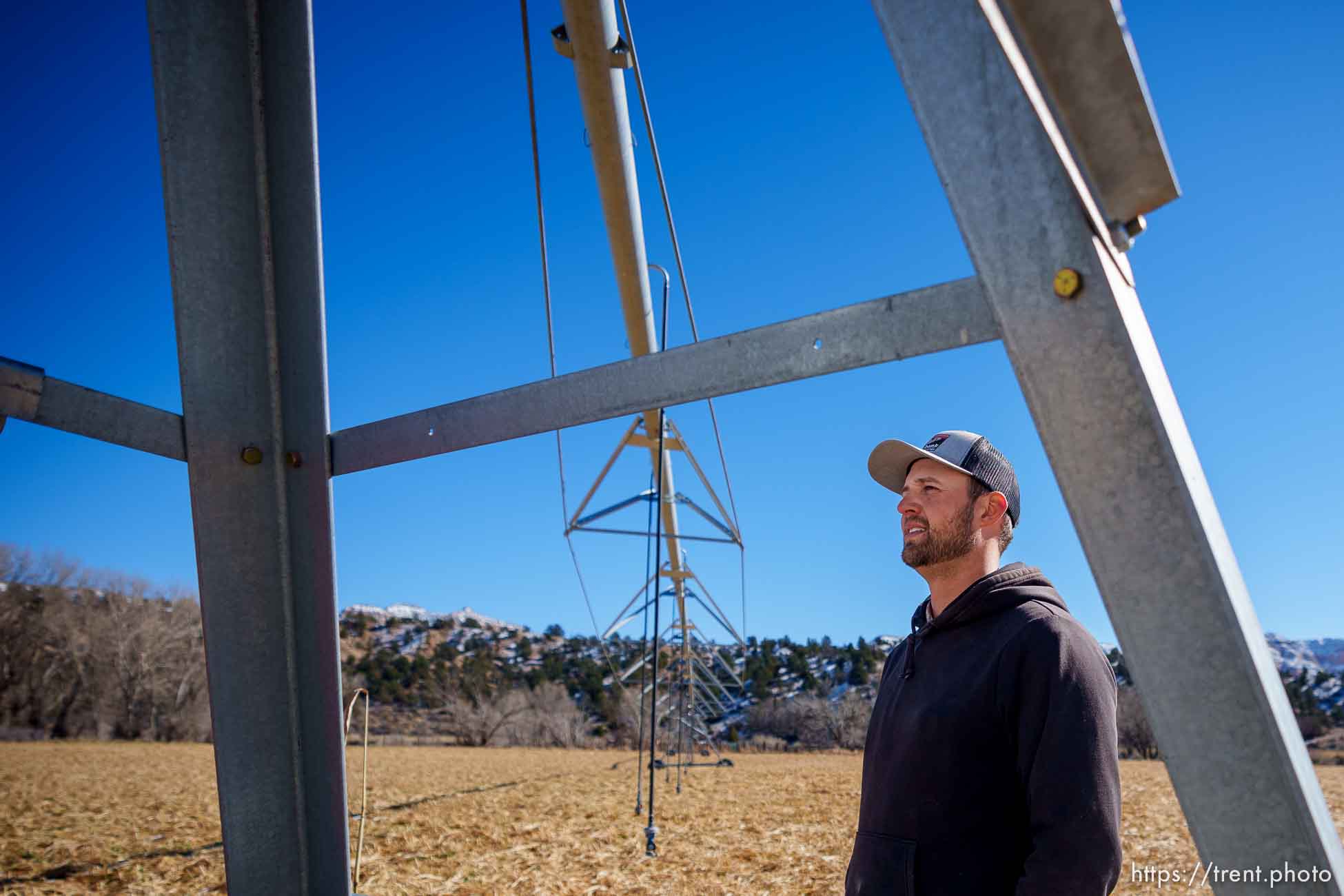 (Trent Nelson  |  The Salt Lake Tribune) Clay Hansen stands under a pivot on his family's farm in Mt. Carmel on Thursday, Nov. 10, 2022.