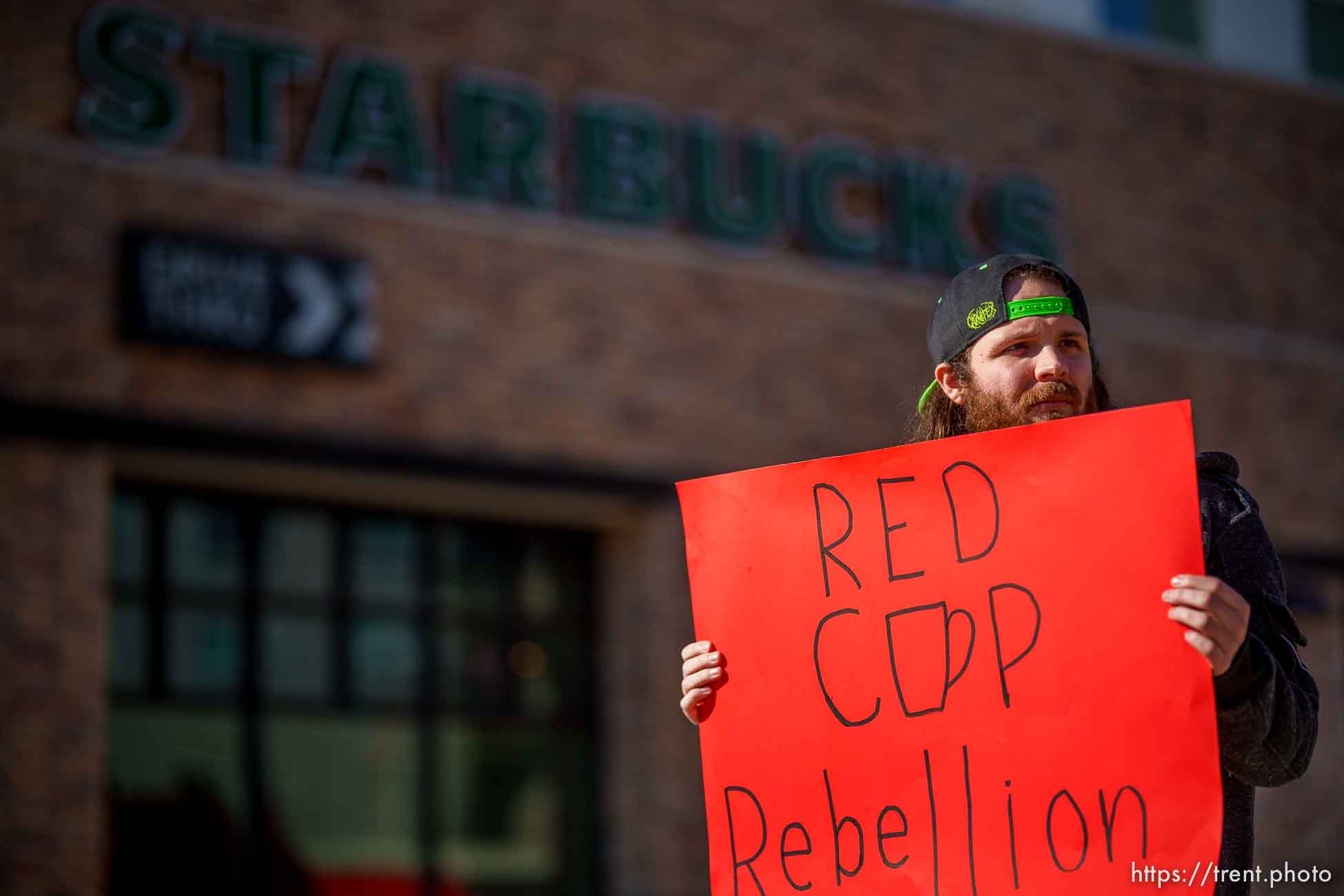 (Trent Nelson  |  The Salt Lake Tribune) Starbucks workers strike in front of 400 South Salt Lake City location as part of Red Cup Rebellion, taking place across the country on Thursday, Nov. 17, 2022. Johnathan Sheen at right.