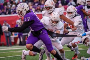 (Trent Nelson  |  The Salt Lake Tribune) Timpview defenders try to hold back Lehi's Makafefie Havea (17) in the 5A high school football championship game at Rice-Eccles Stadium in Salt Lake City on Friday, Nov. 18, 2022.