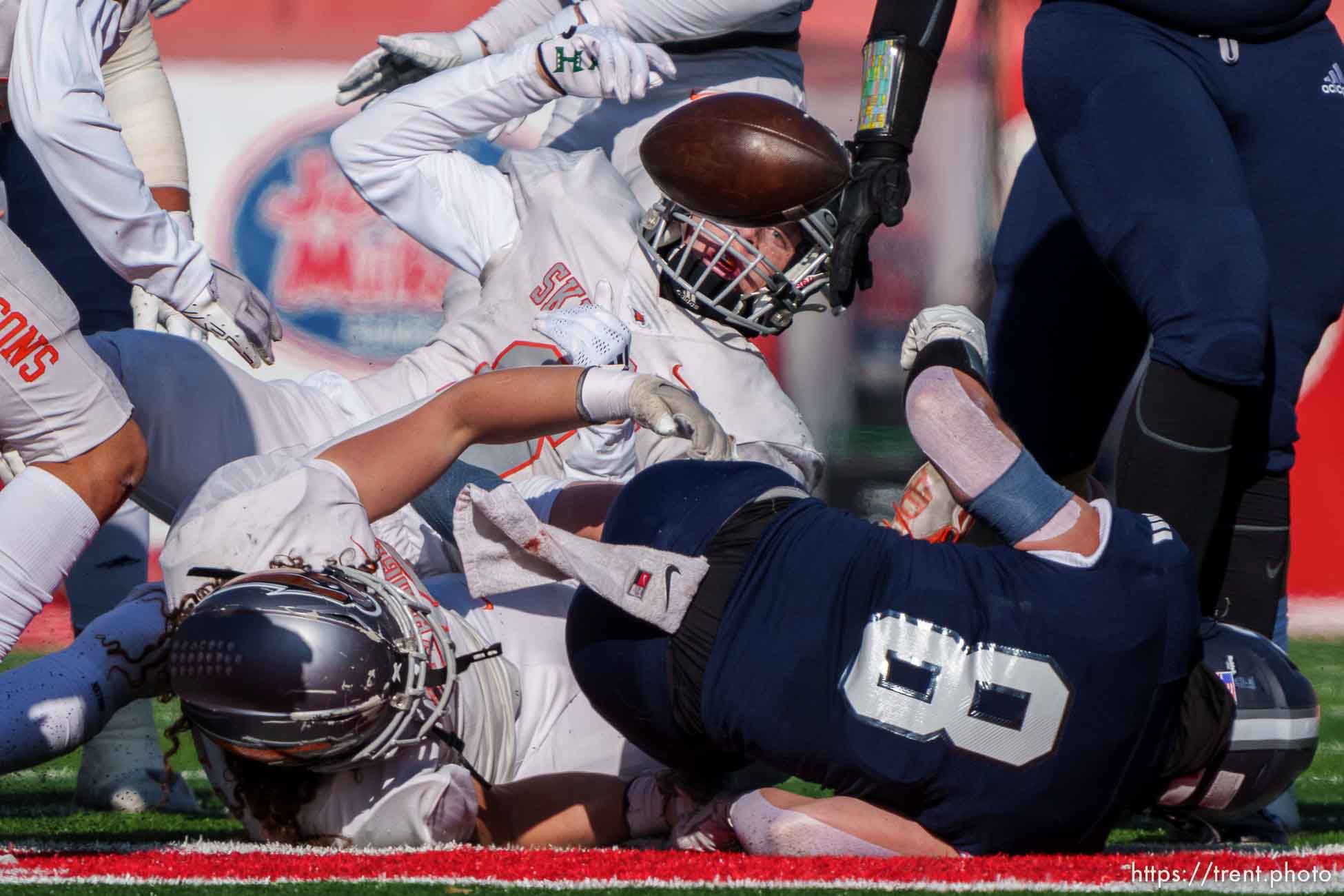 (Trent Nelson  |  The Salt Lake Tribune) Skyridge defenders knock the ball from Corner Canyon's Drew Patterson (8) in the 6A high school football championship game at Rice-Eccles Stadium in Salt Lake City on Friday, Nov. 18, 2022.