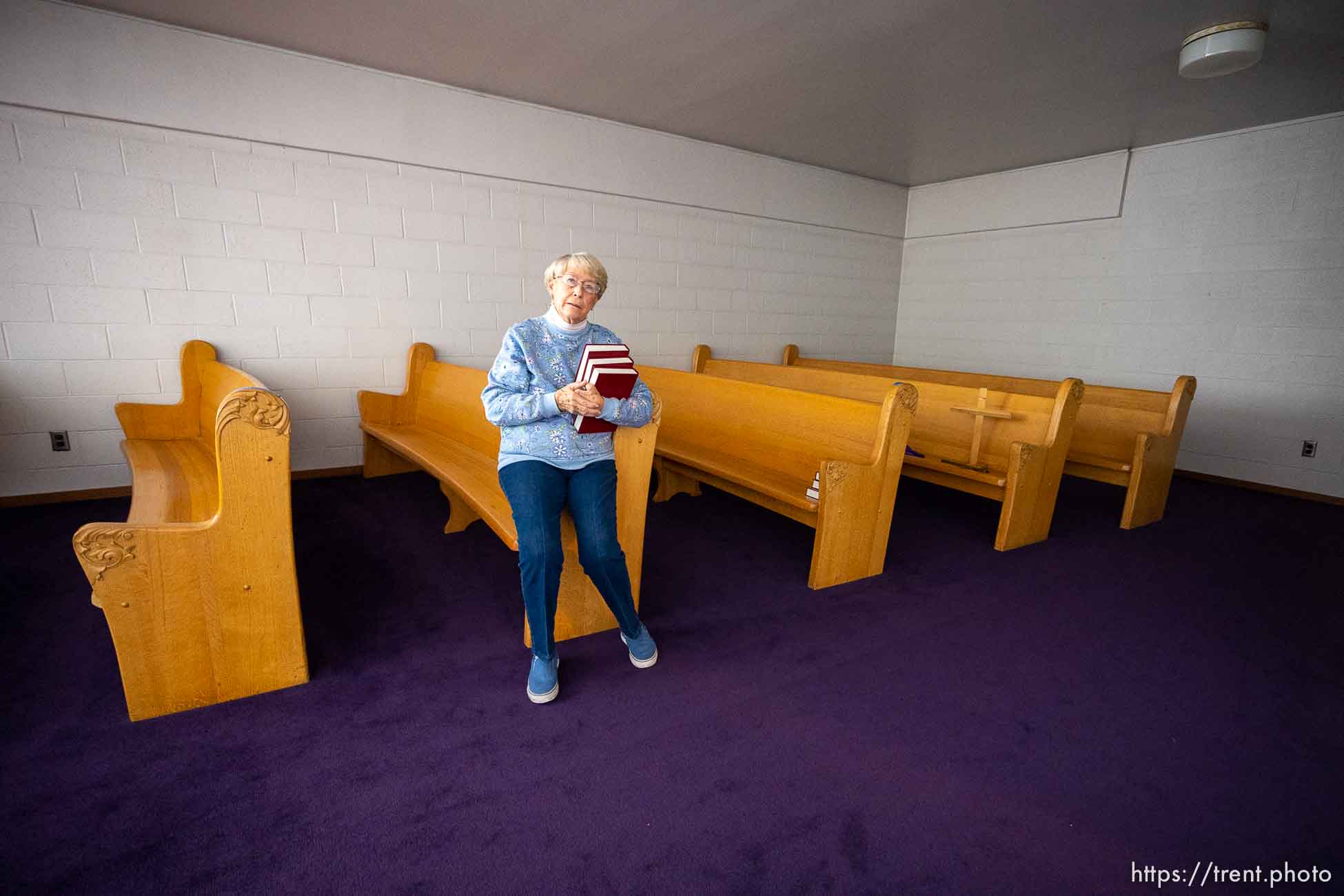 (Trent Nelson  |  The Salt Lake Tribune) Carla McIntire gathers hymnals at First Congregational Church in Salt Lake City on Friday, Dec. 2, 2022.