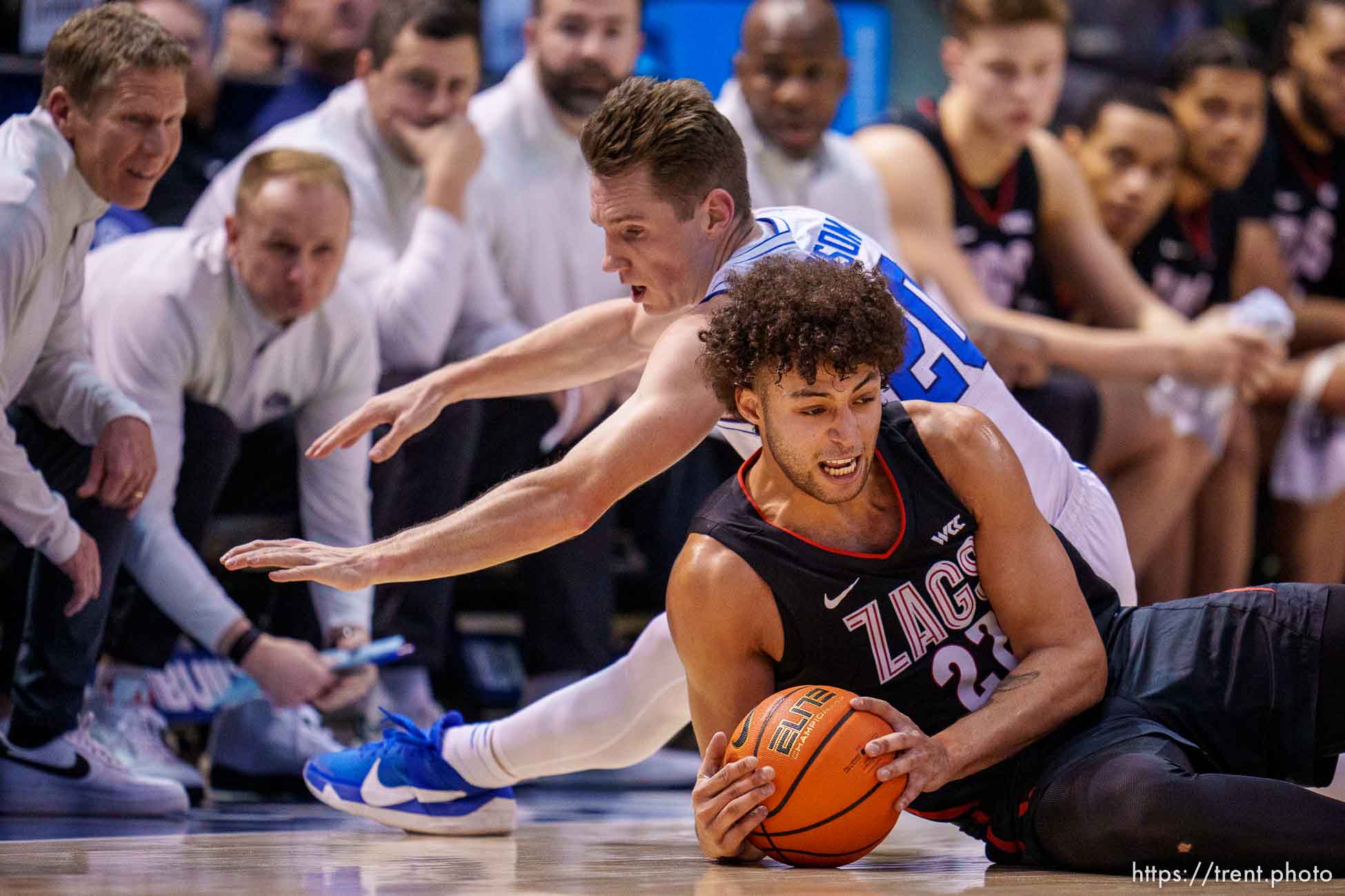 (Trent Nelson  |  The Salt Lake Tribune) Gonzaga Bulldogs forward Anton Watson (22) and Brigham Young Cougars guard Spencer Johnson (20) dive for a loose ball as BYU hosts Gonzaga, NCAA basketball in Provo on Thursday, Jan. 12, 2023.