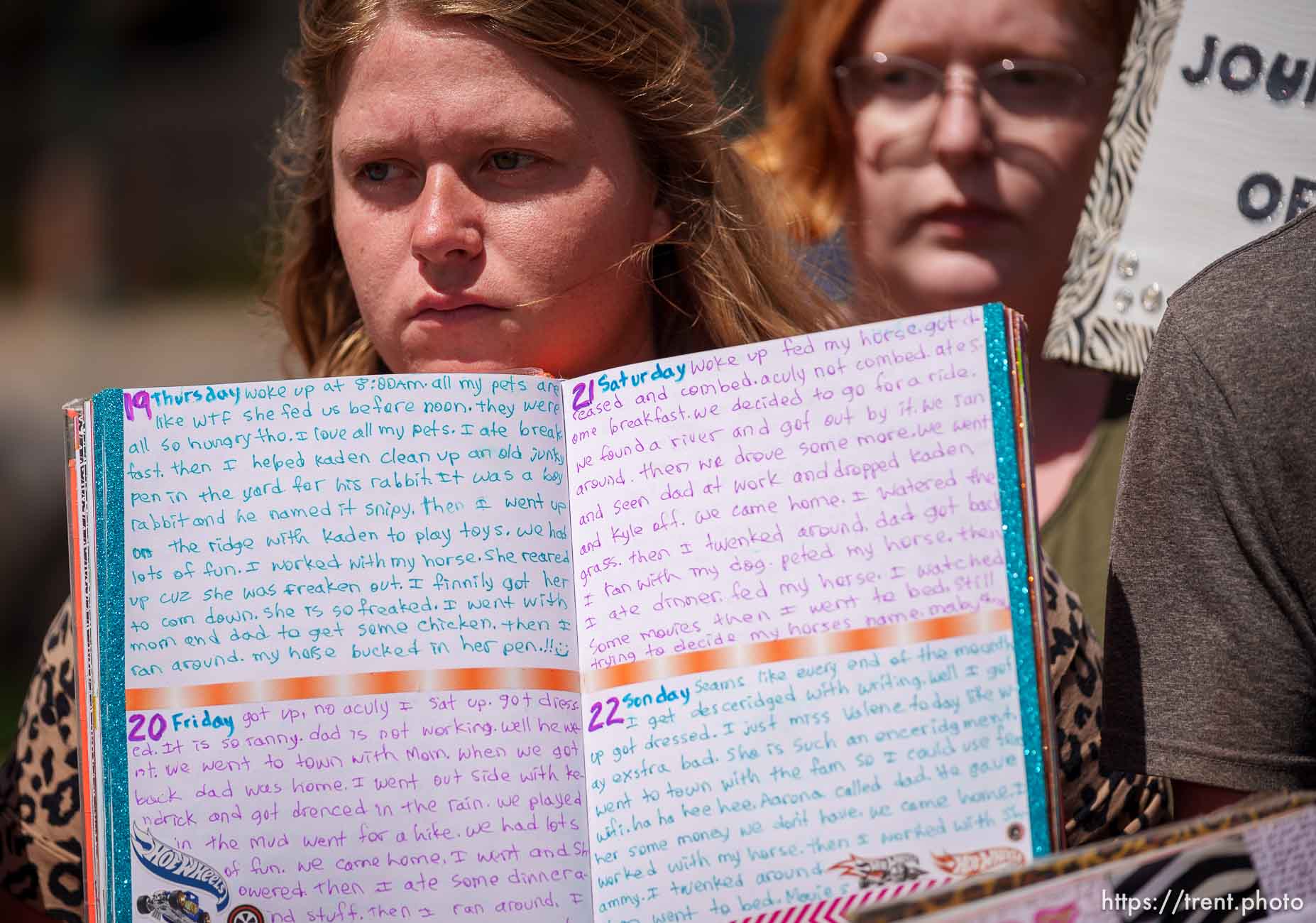 (Trent Nelson  |  The Salt Lake Tribune) Leandra Black and her siblings hold the journals she kept while being held away from her family, at a news conference to draw  
attention to missing FLDS children, in Cedar City on Monday, April 17, 2023. With her are her siblings Kaelee Black and Kaden Black.
