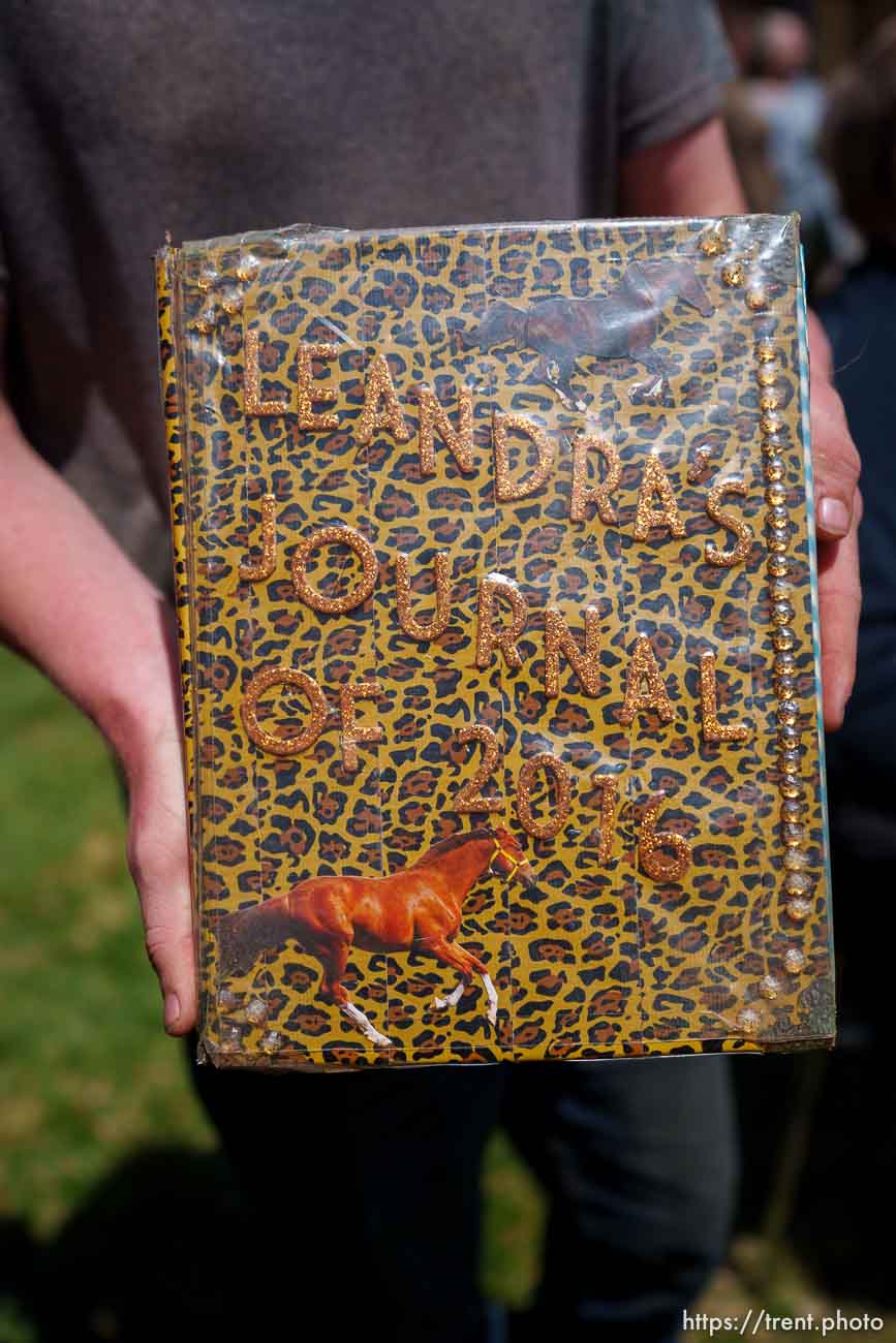(Trent Nelson  |  The Salt Lake Tribune) Kaden Black holds one of the journals his sister Leandra kept while being hidden away from her family, at a news conference in Cedar City on Monday, April 17, 2023.