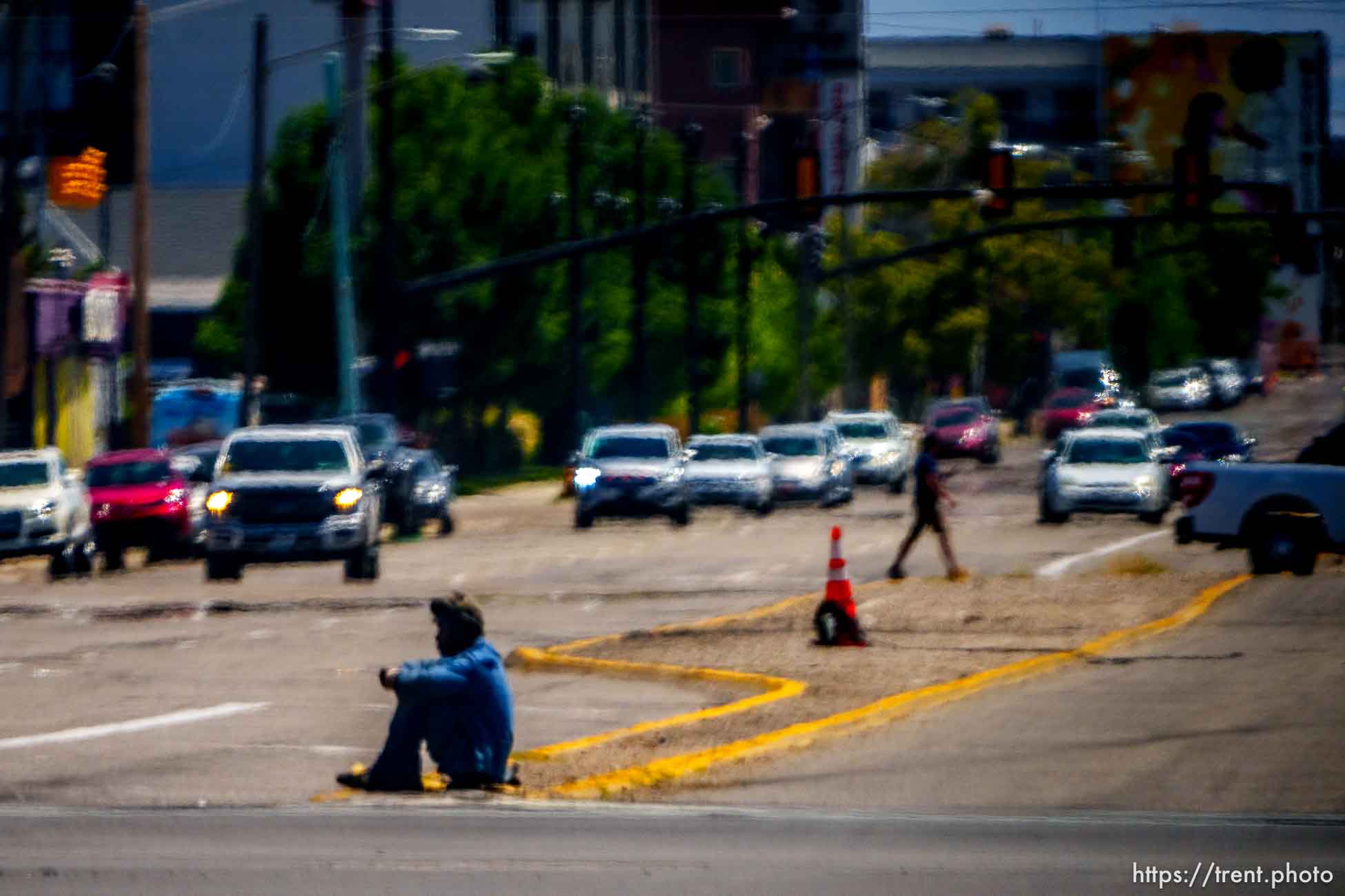 man sitting in the street, Salt Lake City, Tuesday July 11, 2023.