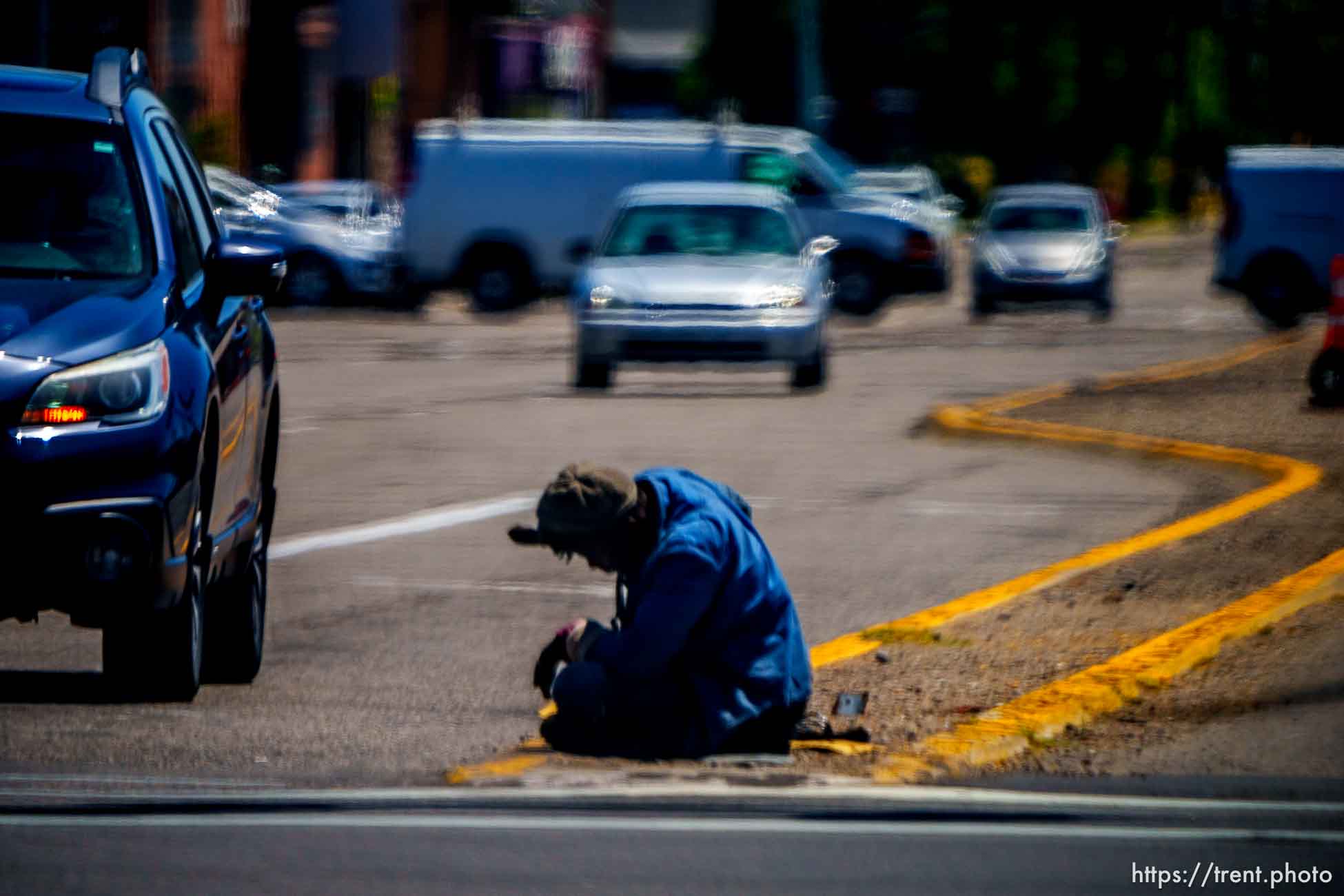 man sitting in the street, Salt Lake City, Tuesday July 11, 2023.