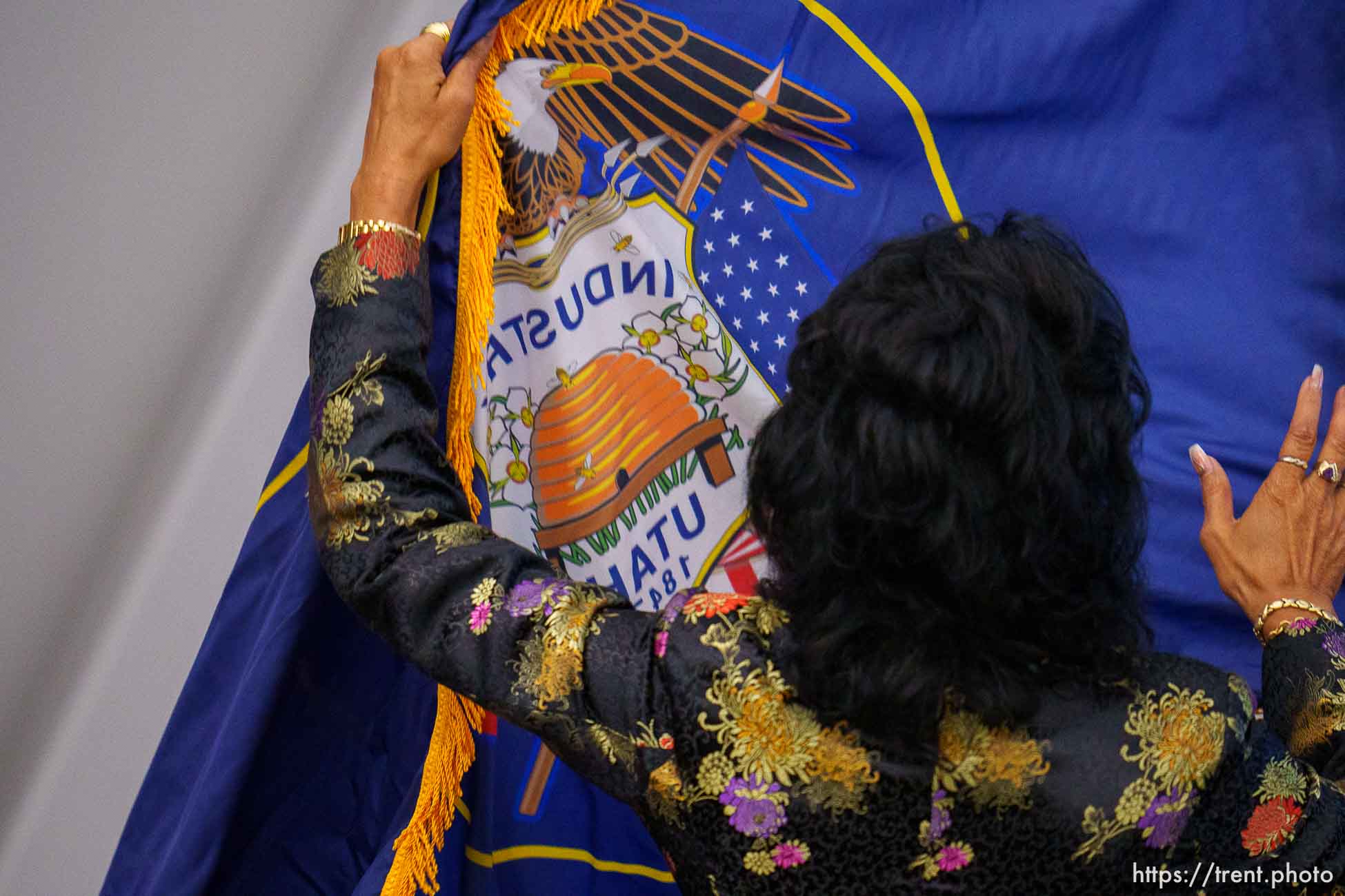 (Trent Nelson  |  The Salt Lake Tribune) A woman posts the traditional state flag as the Utah Republican Party holds its quarterly State Central Committee meeting in Sandy on Saturday, Aug. 19, 2023.