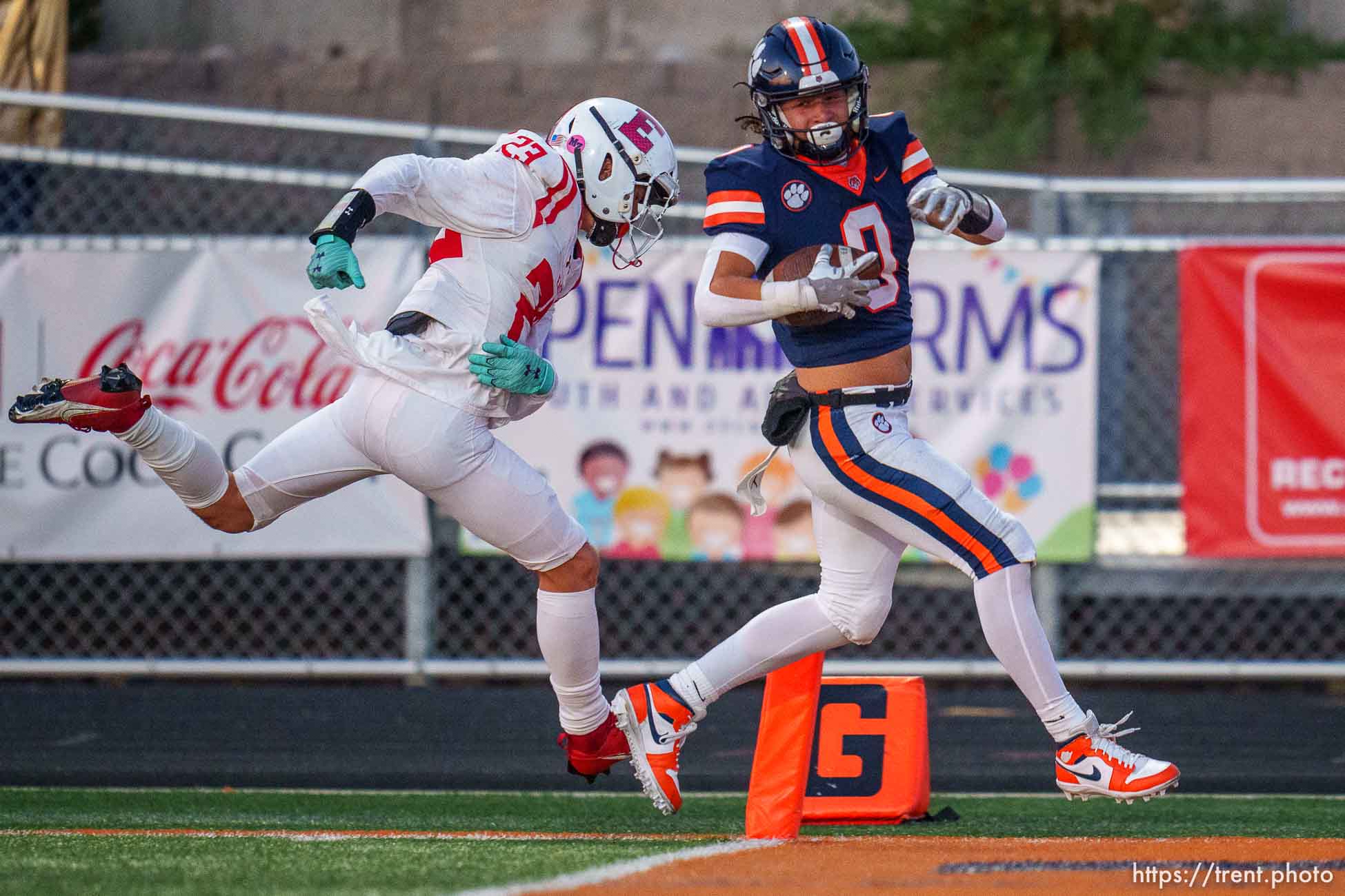 (Trent Nelson  |  The Salt Lake Tribune) Brighton hosts East, high school football in Cottonwood Heights on Friday, Sept. 22, 2023. Nash Matheson (0) scores a touchdown with David Bergstedt (23) defending.