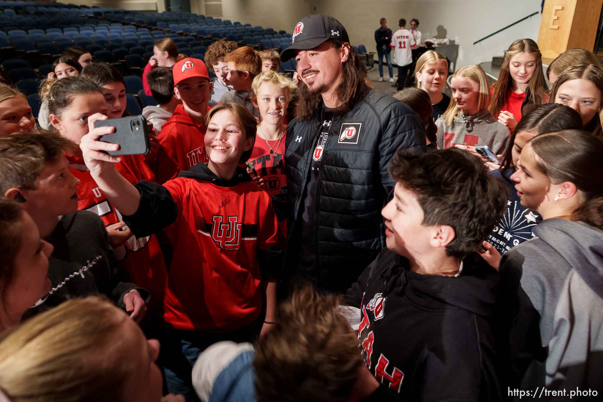 (Trent Nelson  |  The Salt Lake Tribune) Utah quarterback Cam Rising poses for photos with students at Eastmont Middle School in Sandy on Tuesday, Nov. 28, 2023.