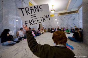 (Trent Nelson  |  The Salt Lake Tribune) Activists in support of transgender rights hold a sit-in in front of a bathroom at the Utah Capitol in Salt Lake City on Thursday, Feb. 22, 2024.