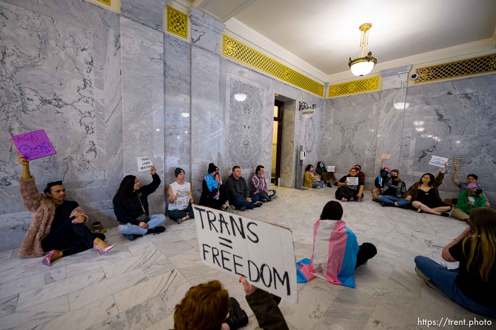(Trent Nelson  |  The Salt Lake Tribune) Activists in support of transgender rights hold a sit-in in front of a bathroom at the Utah Capitol in Salt Lake City on Thursday, Feb. 22, 2024.