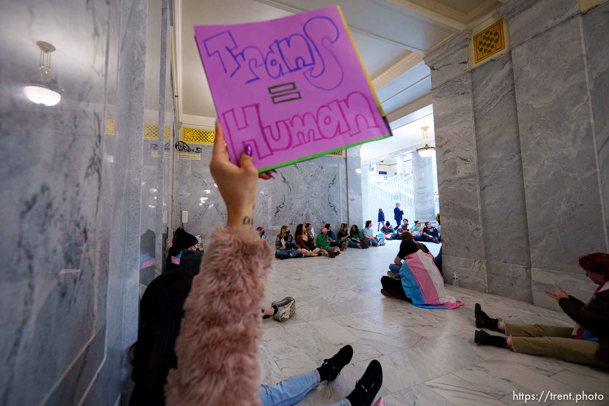 (Trent Nelson  |  The Salt Lake Tribune) Activists in support of transgender rights hold a sit-in in front of a bathroom at the Utah Capitol in Salt Lake City on Thursday, Feb. 22, 2024.