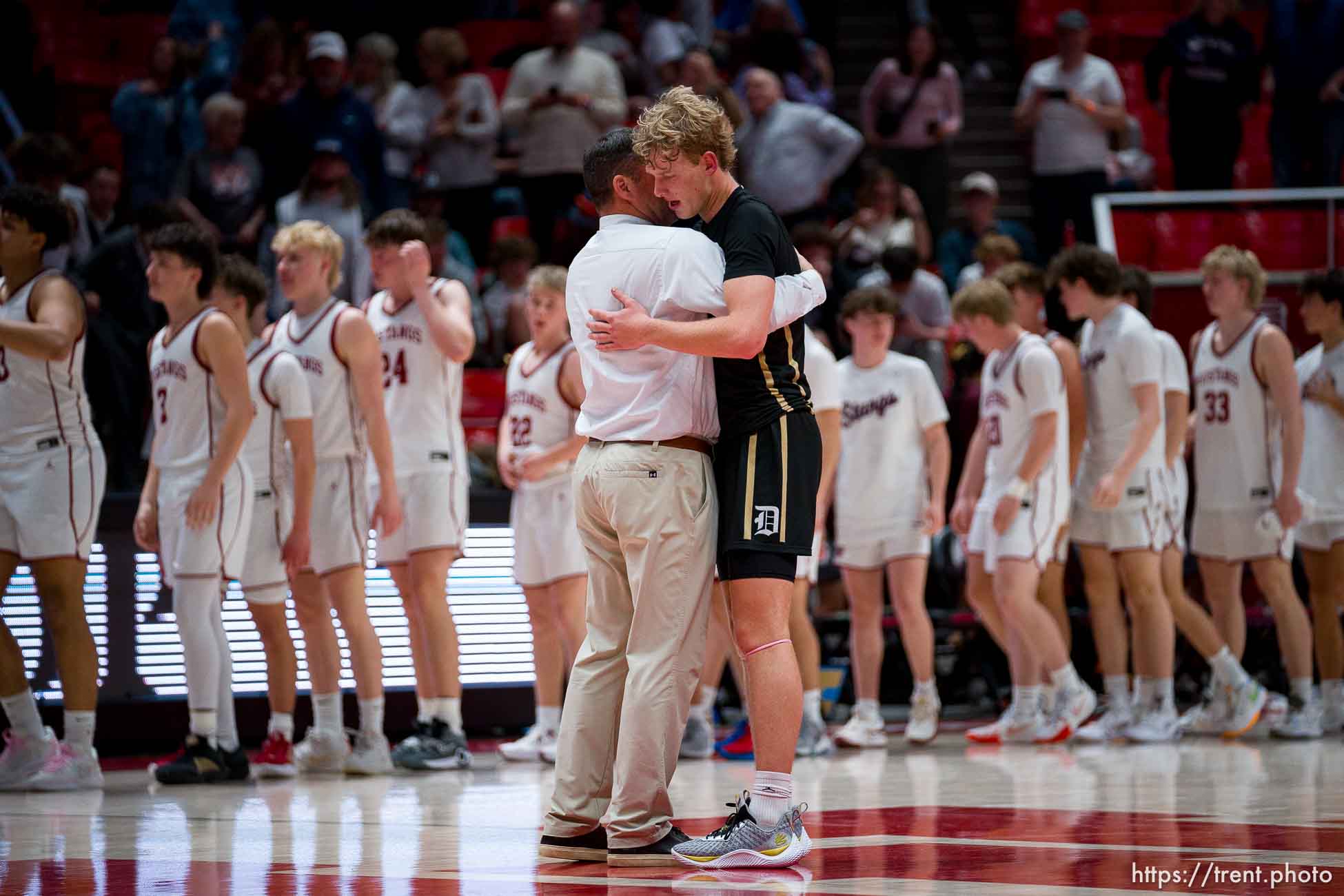 (Trent Nelson  |  The Salt Lake Tribune) 
Davis Coach Chad Sims embraces Zach Fisher as Herriman defeats Davis  in the 6A high school boys basketball tournament in Salt Lake City on Monday, Feb. 26, 2024.