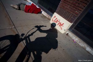 covered man on street, cunt graffiti, State Street, Salt Lake City on Wednesday, March 20, 2024.