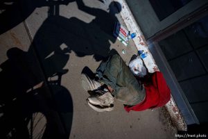 covered man on street, cunt graffiti, State Street, Salt Lake City on Wednesday, March 20, 2024.