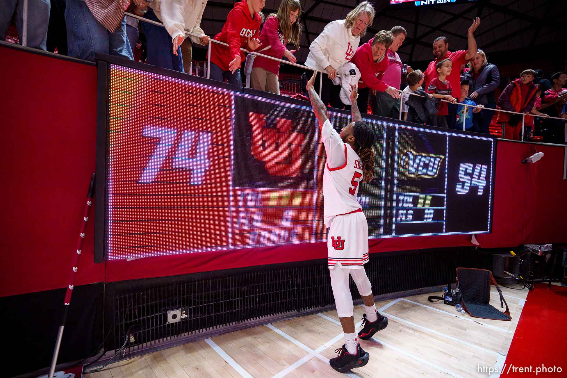 (Trent Nelson  |  The Salt Lake Tribune) Utah Utes guard Deivon Smith (5) high-fives fans after the win as Utah hosts Virginia Commonwealth in the NIT quarterfinals, NCAA basketball in Salt Lake City on Wednesday, March 27, 2024.