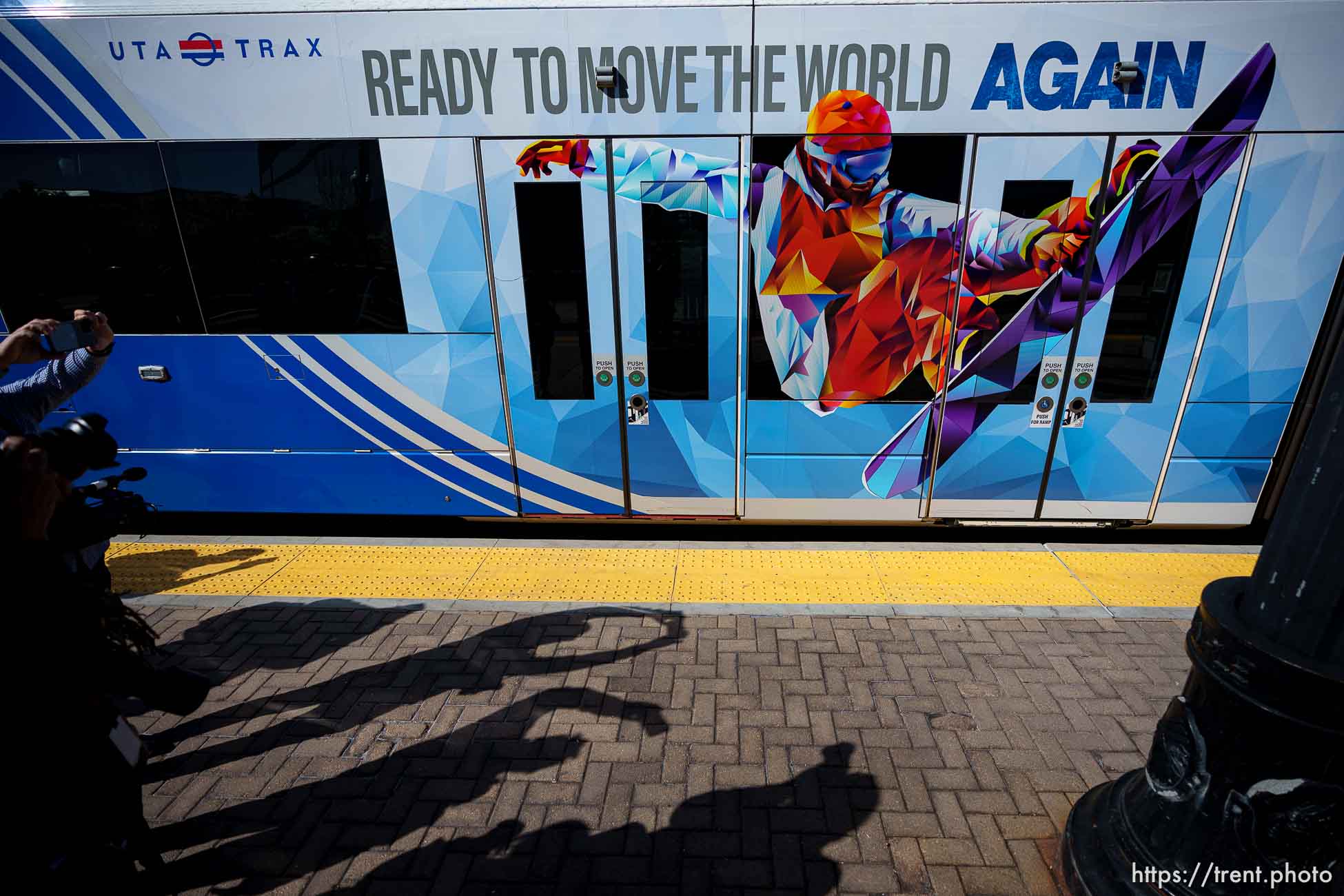(Trent Nelson  |  The Salt Lake Tribune) An Olympic-wrapped UTA TRAX light rail train arrives at the Arena Station next to the Delta Center in Salt Lake City on Wednesday, April 10, 2024.