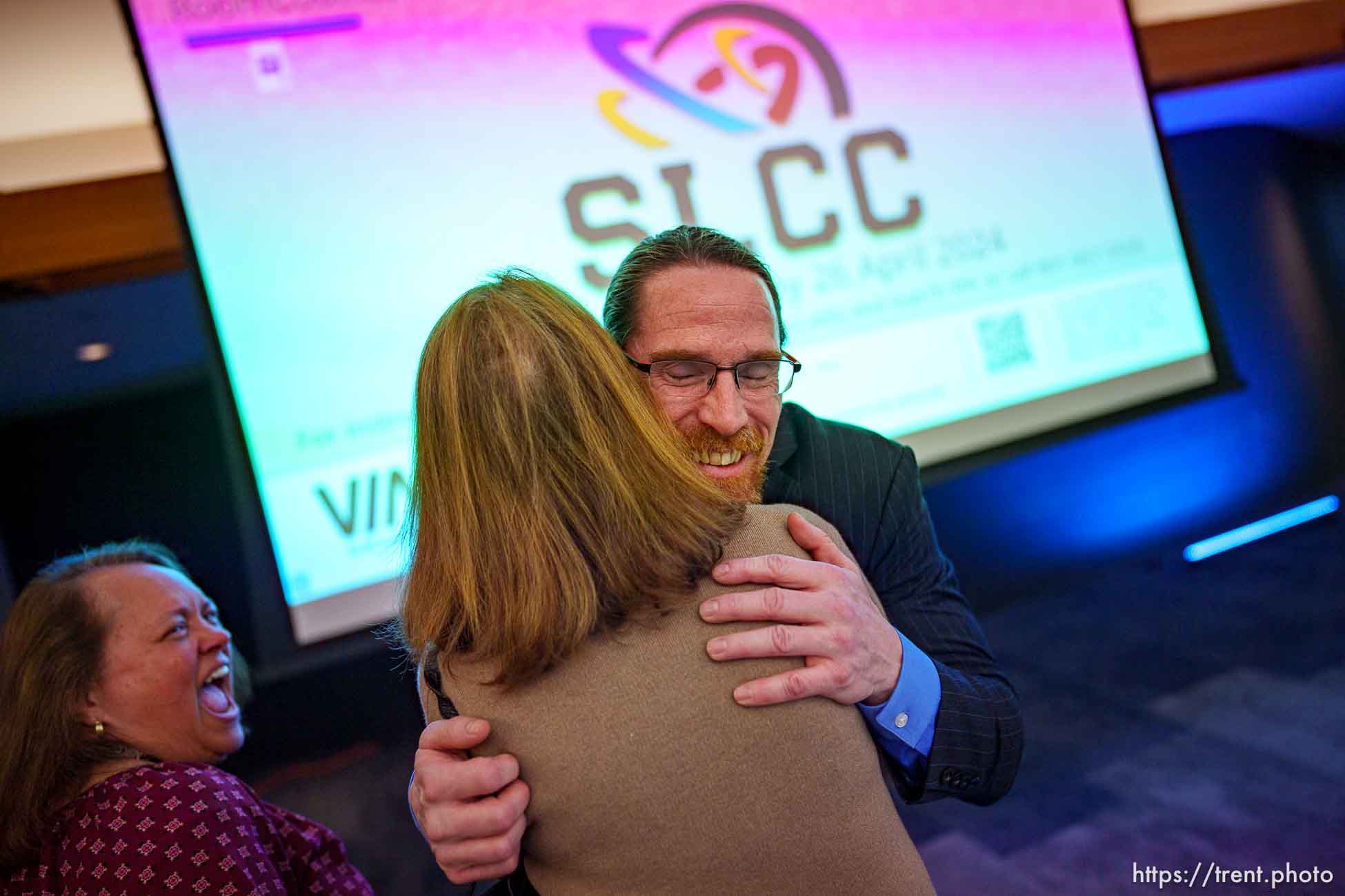 (Trent Nelson  |  The Salt Lake Tribune) Greg Peterson embraces trustee Coralie Alder after being named the new president of Salt Lake Community College, in Taylorsville on Friday, April 26, 2024. At left is Samantha Faupula.