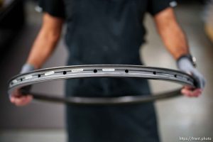 (Trent Nelson  |  The Salt Lake Tribune) Longtime ENVE employee Oscar Gorritti holds a carbon fiber rim at the company's Ogden facility on Tuesday, May 28, 2024.