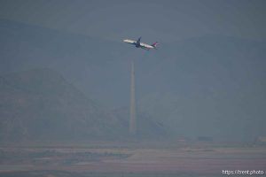 (Trent Nelson  |  The Salt Lake Tribune) A passenger jet takes off in a dusty, hazy Salt Lake Valley on Wednesday, July 10, 2024.