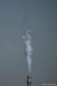 (Trent Nelson  |  The Salt Lake Tribune) A plane flies into a dusty, hazy Salt Lake Valley on Wednesday, July 10, 2024.