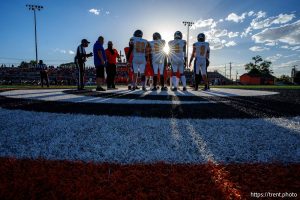 (Trent Nelson  |  The Salt Lake Tribune) Players meet for the coin toss as Murray hosts Taylorsville, high school football  on Friday, Aug. 23, 2024.