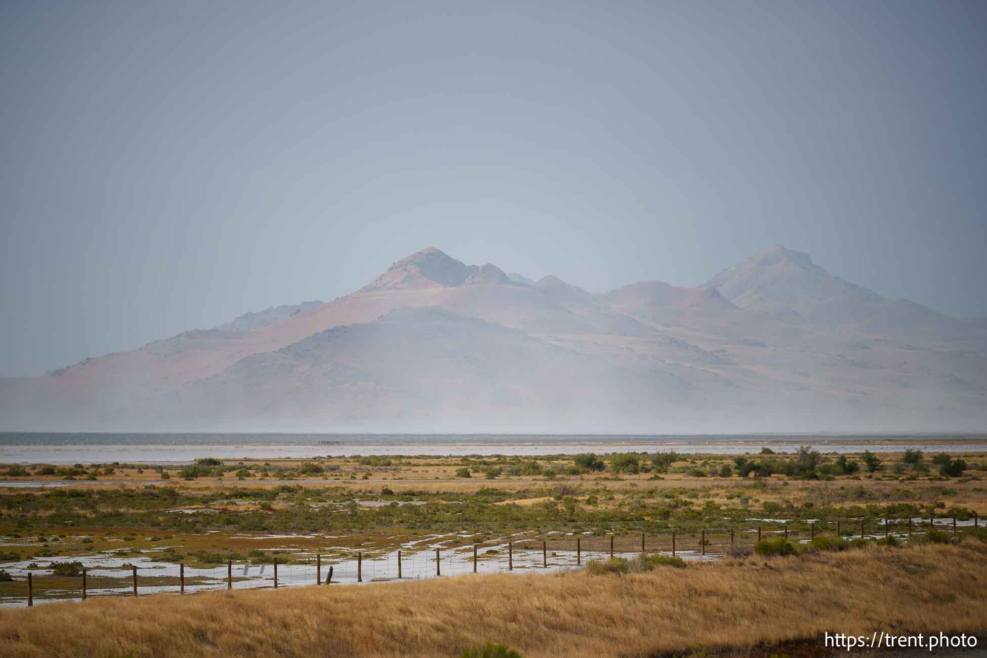 (Trent Nelson  |  The Salt Lake Tribune) Dust blows off the Great Salt Lake past Antelope Island on Saturday, Aug. 24, 2024.