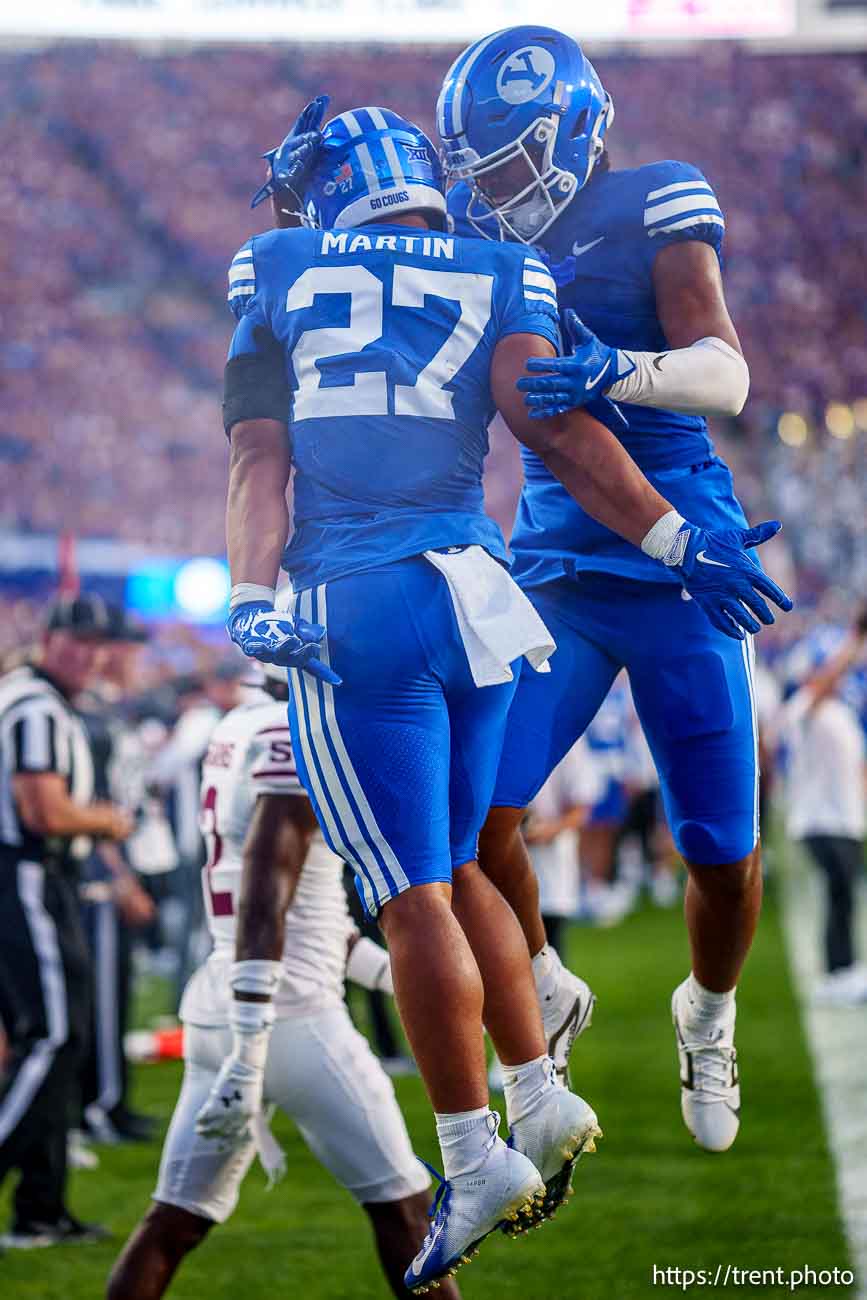 (Trent Nelson  |  The Salt Lake Tribune) Brigham Young Cougars running back LJ Martin (27) and Brigham Young Cougars tight end Keanu Hill (1) celebrate a touchdown as BYU hosts Southern Illinois, NCAA football in Provo on Saturday, Aug. 31, 2024.