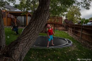 (Trent Nelson  |  The Salt Lake Tribune) Harper Tribe on the family's backyard trampoline in South Jordan on Monday, Sept. 16, 2024. At left is Miriam Tribe.