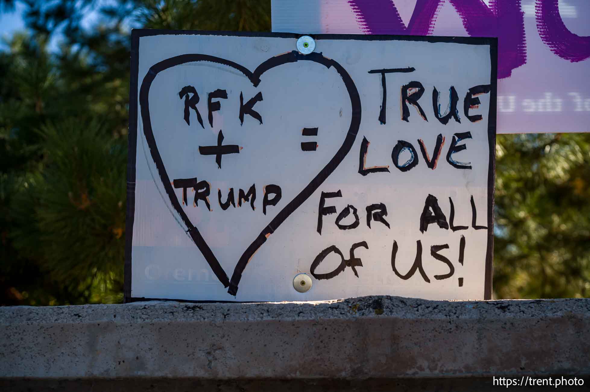 Donald Trump signs in Orem on Monday, Sept. 30, 2024.