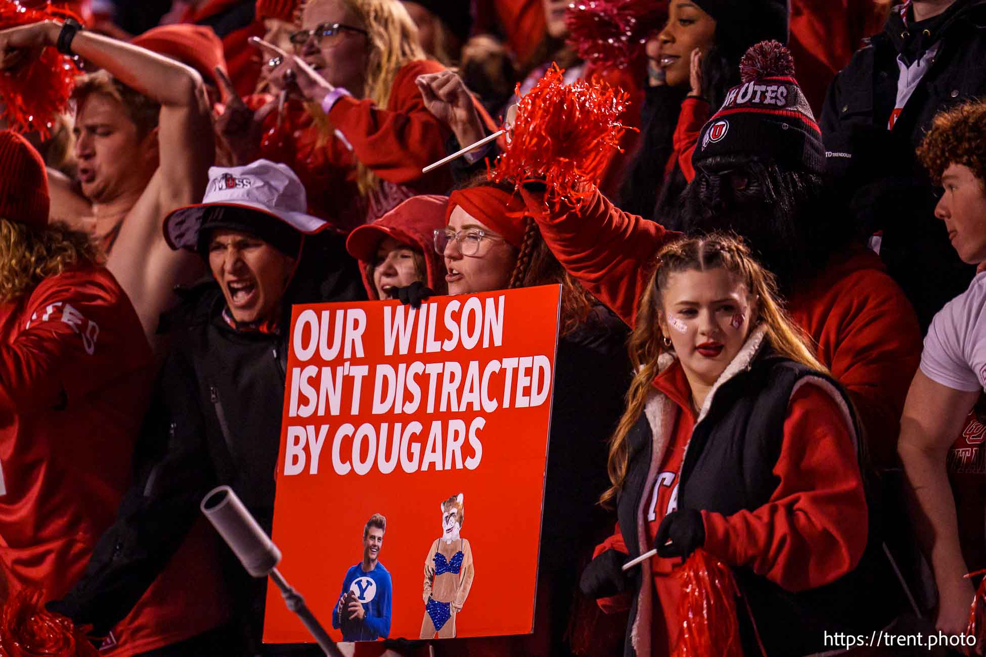 (Trent Nelson  |  The Salt Lake Tribune) Zach Wilson and Cosmo on a sign as Utah hosts BYU, NCAA football in Salt Lake City on Saturday, Nov. 9, 2024.