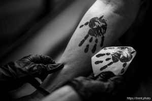 (Trent Nelson  |  The Salt Lake Tribune) Misty Anais stencils Jamie Walker at Eminent Ink Tattoos in Midvale, raising funds for the National Indigenous Women's Resource Center on Saturday, Nov. 23, 2024.