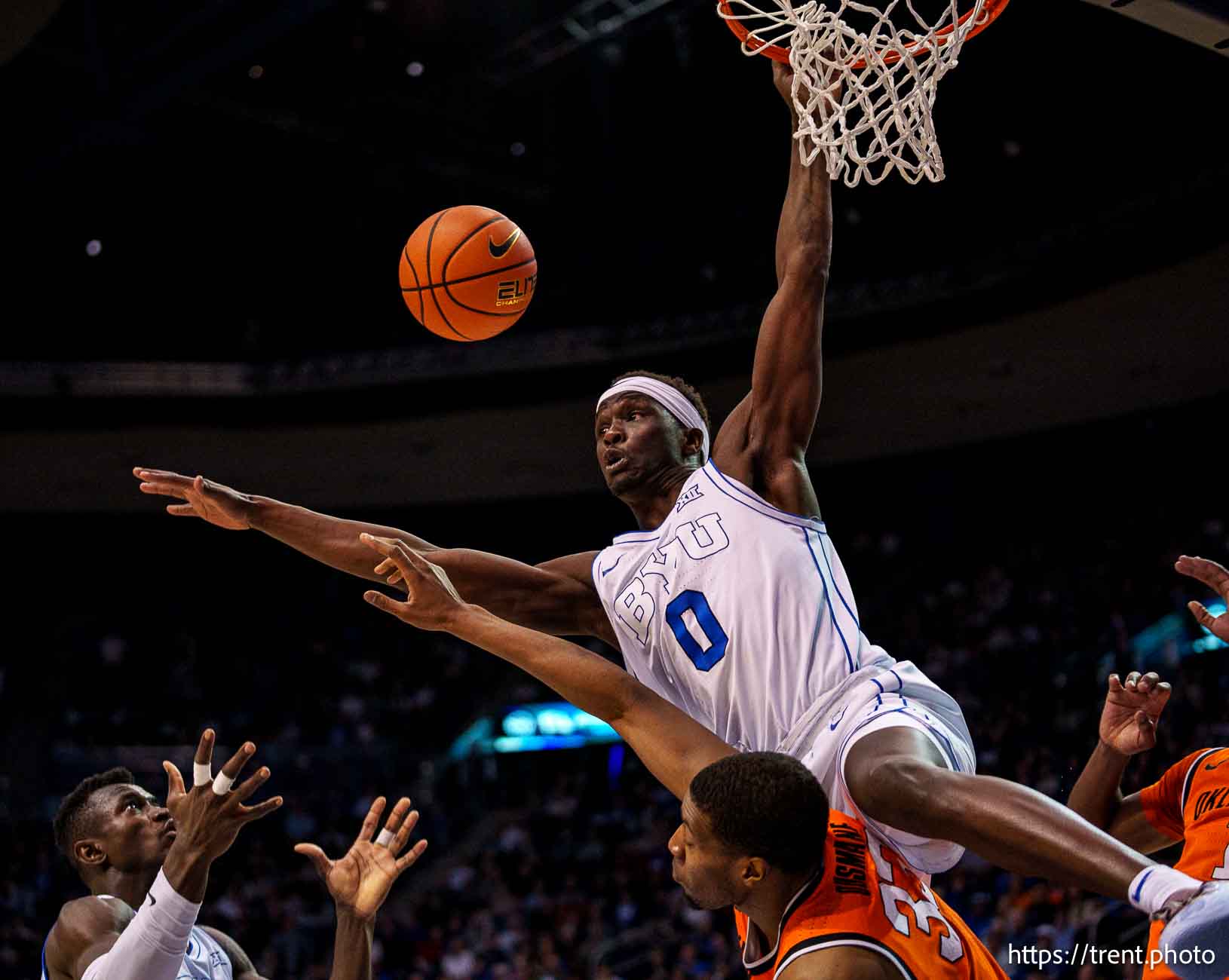 (Trent Nelson  |  The Salt Lake Tribune) Brigham Young Cougars forward Mawot Mag (0) goes over Oklahoma State Cowboys forward Abou Ousmane (33) as BYU hosts Oklahoma State, NCAA basketball in Provo on Tuesday, Jan. 14, 2025. Brigham Young Cougars center Keba Keita (13) at left.