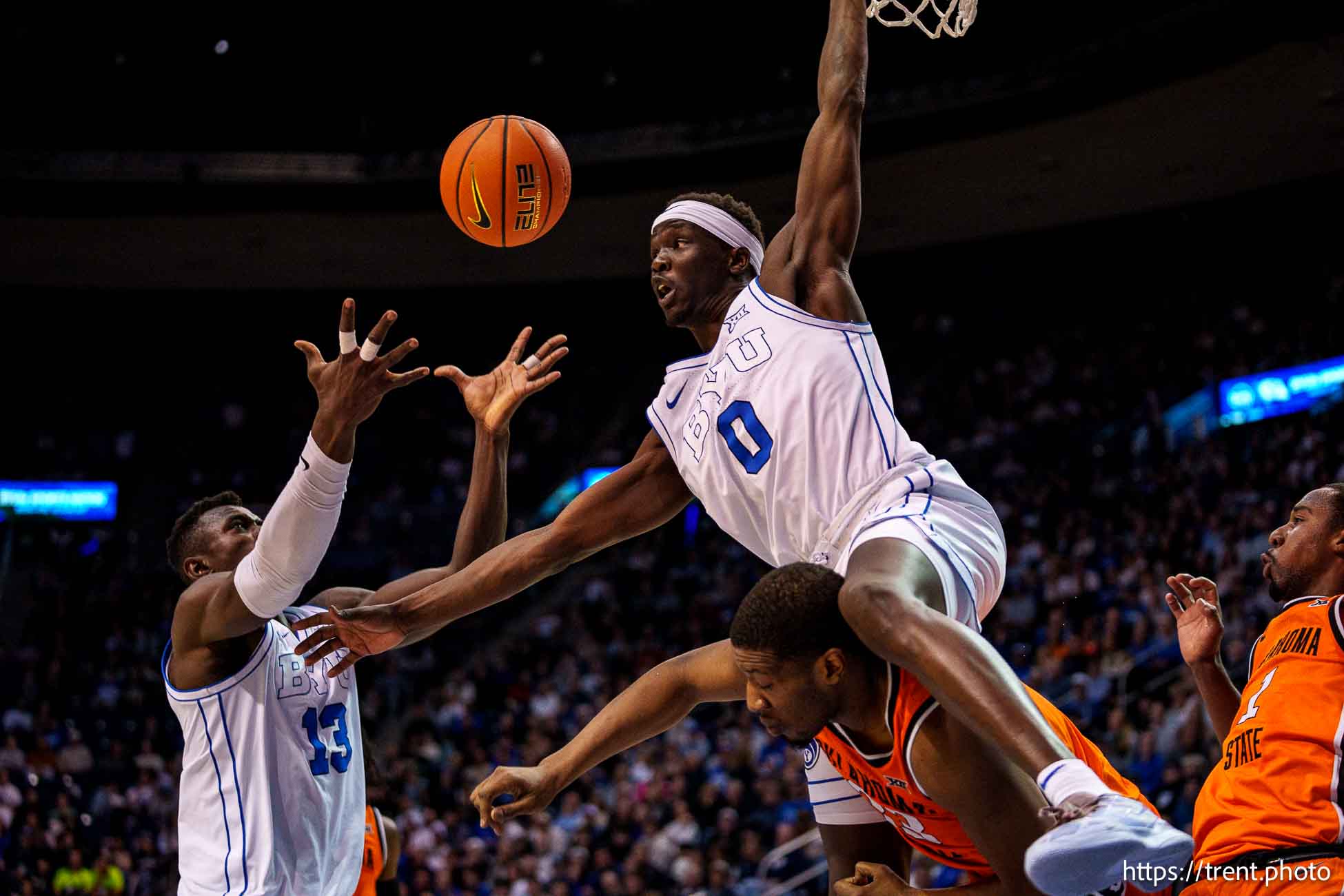 (Trent Nelson  |  The Salt Lake Tribune) Brigham Young Cougars forward Mawot Mag (0) goes over Oklahoma State Cowboys forward Abou Ousmane (33) as BYU hosts Oklahoma State, NCAA basketball in Provo on Tuesday, Jan. 14, 2025. Brigham Young Cougars center Keba Keita (13) at left.