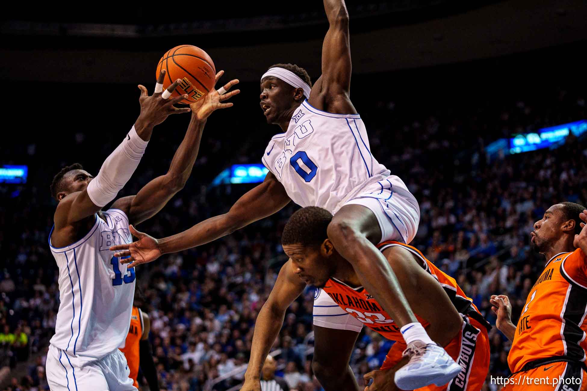 (Trent Nelson  |  The Salt Lake Tribune) Brigham Young Cougars forward Mawot Mag (0) goes over Oklahoma State Cowboys forward Abou Ousmane (33) as BYU hosts Oklahoma State, NCAA basketball in Provo on Tuesday, Jan. 14, 2025. Brigham Young Cougars center Keba Keita (13) at left.