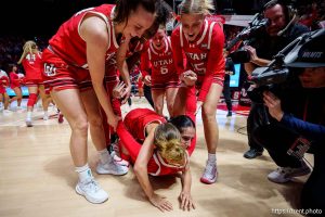 (Trent Nelson  |  The Salt Lake Tribune) Utah players dogpile on Utah Utes guard Matyson Wilke (23) after her game-winning shot as Utah hosts BYU, NCAA basketball in Salt Lake City on Saturday, March 1, 2025.