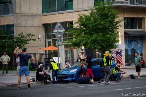 (Trent Nelson | The Salt Lake Tribune) A man lays injured on the street as police respond to a reported shooting during 'No Kings' protest march in Salt Lake City, Saturday, June 14, 2025. (full sequence, not initial select)