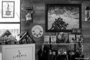 (Trent Nelson  |  The Salt Lake Tribune) Wall decorations and a safe meant to securely hold the weapons of people in distress, at Cache Coffee in Logan on Thursday, Dec. 11, 2025.