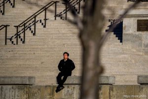 (Trent Nelson  |. The Salt Lake Tribune) A person sits in the early morning sun at the Utah Capitol in Salt Lake City on Monday, Dec. 29, 2025.